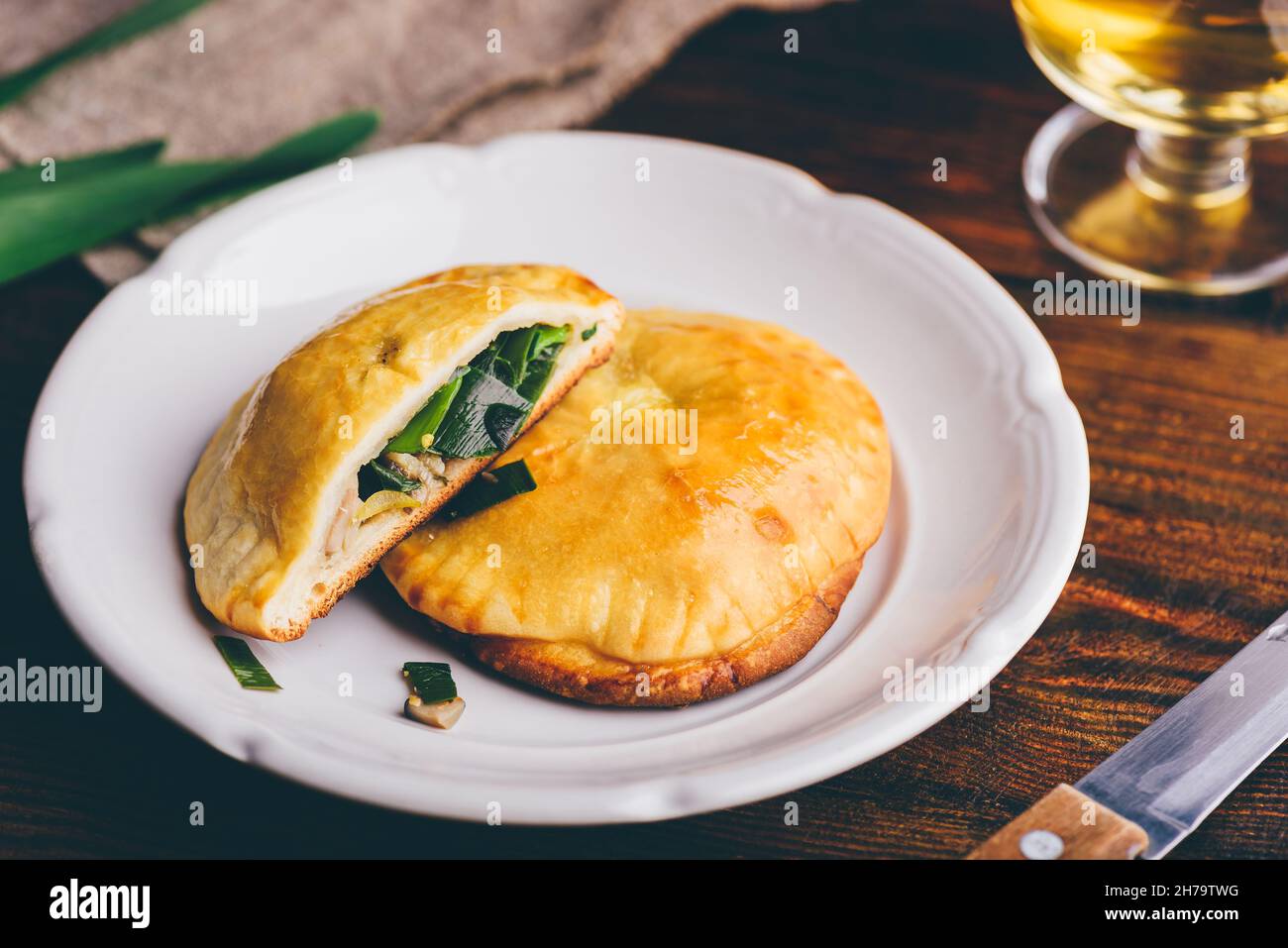 Oven Baked Hand Pies Filled with Chives and Mushrooms on White Plate
