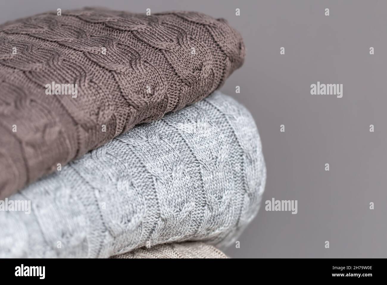 Close-up of textured knitted blankets in a stack. Stock Photo