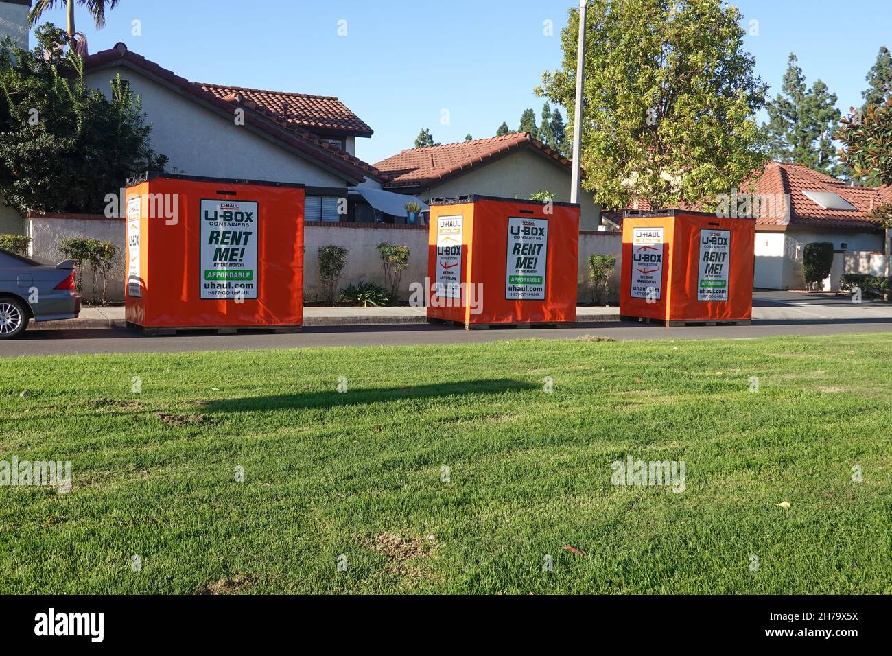 U Haul u-box portable storage pods and moving containers outside a home in California Stock Photo