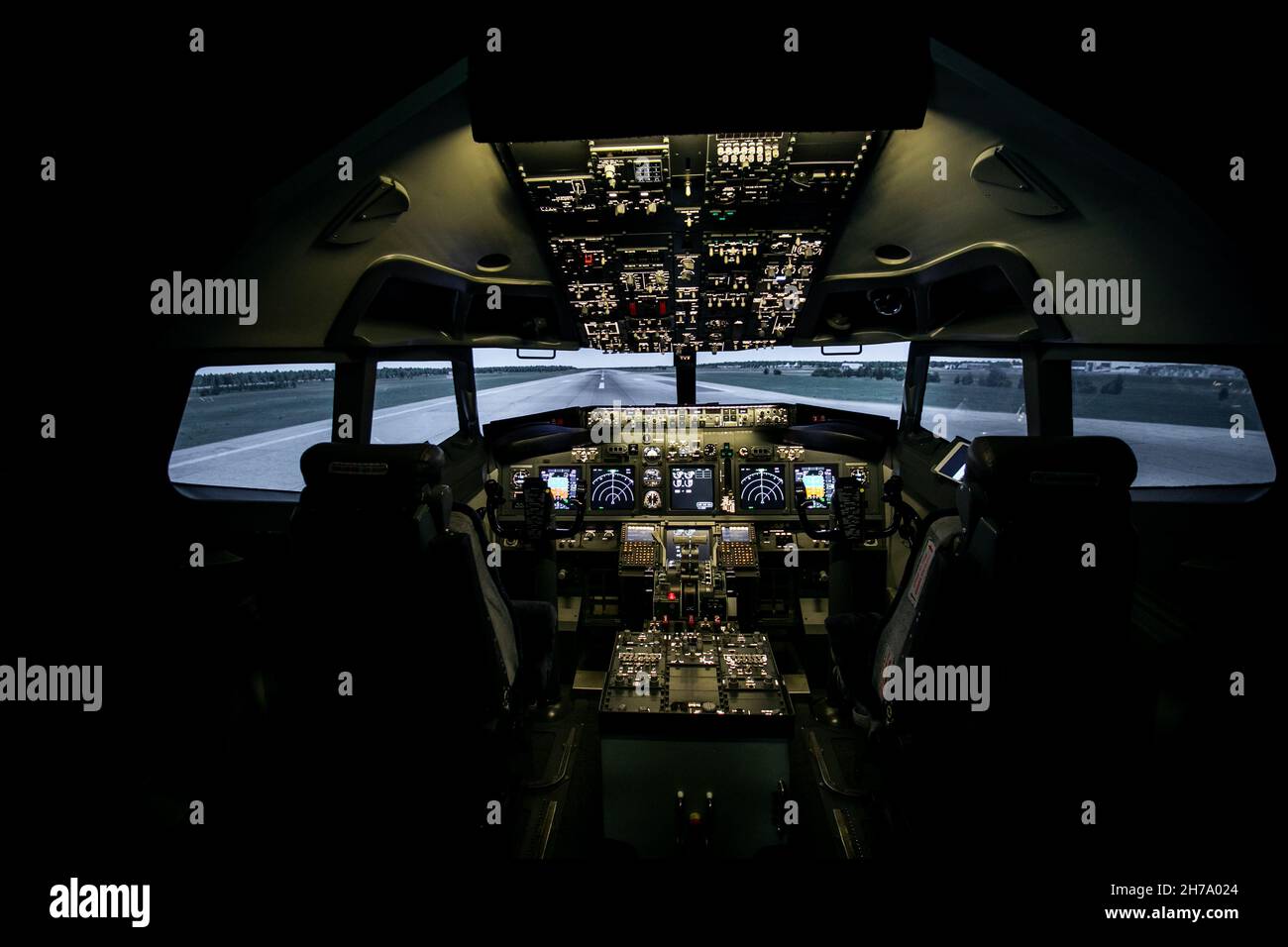 Aircraft interior, cockpit view inside the airliner. Point of view from a pilot place in a plane. Stock Photo