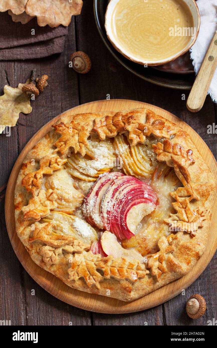 Whole wheat gallet with apple and pear, served with coffee. Rustic style. Stock Photo