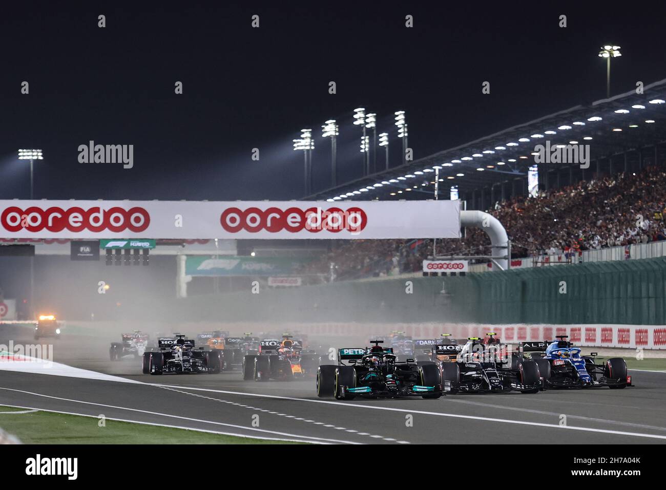 Doha, Qatar. 21st Nov, 2021. (L to R): Lewis Hamilton (GBR) Mercedes AMG F1 W12 leads at the start of the race with Pierre Gasly (FRA) AlphaTauri AT02 and Fernando Alonso (ESP) Alpine F1 Team A521. 21.11.2021. Formula 1 World Championship, Rd 20, Qatar Grand Prix, Doha, Qatar, Race Day. Photo credit should read: XPB/Press Association Images. Credit: XPB Images Ltd/Alamy Live News Stock Photo