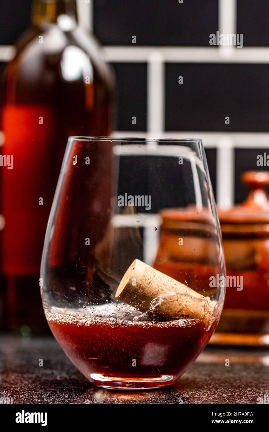Cork falls into a wine glass and splashes Stock Photo Alamy