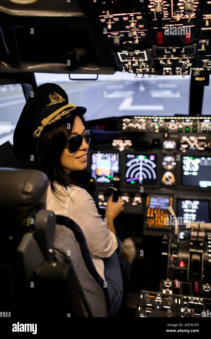 Female pilot the captain of the plane prepares for take-off in the plane cockpit. Stock Photo