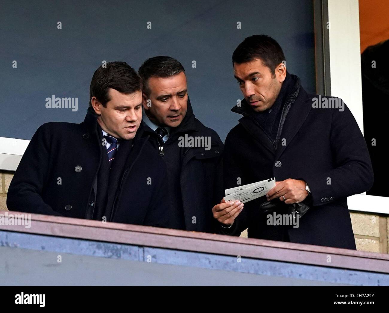 New Rangers manager Giovanni van Bronckhorst (right), Rangers sporting director Ross Wilson (left) and and director of finance & football administration Andrew Dickson in the stands during the Premier Sports Cup semi-final match at Ibrox Stadium, Glasgow. Picture date: Sunday November 21, 2021. Stock Photo