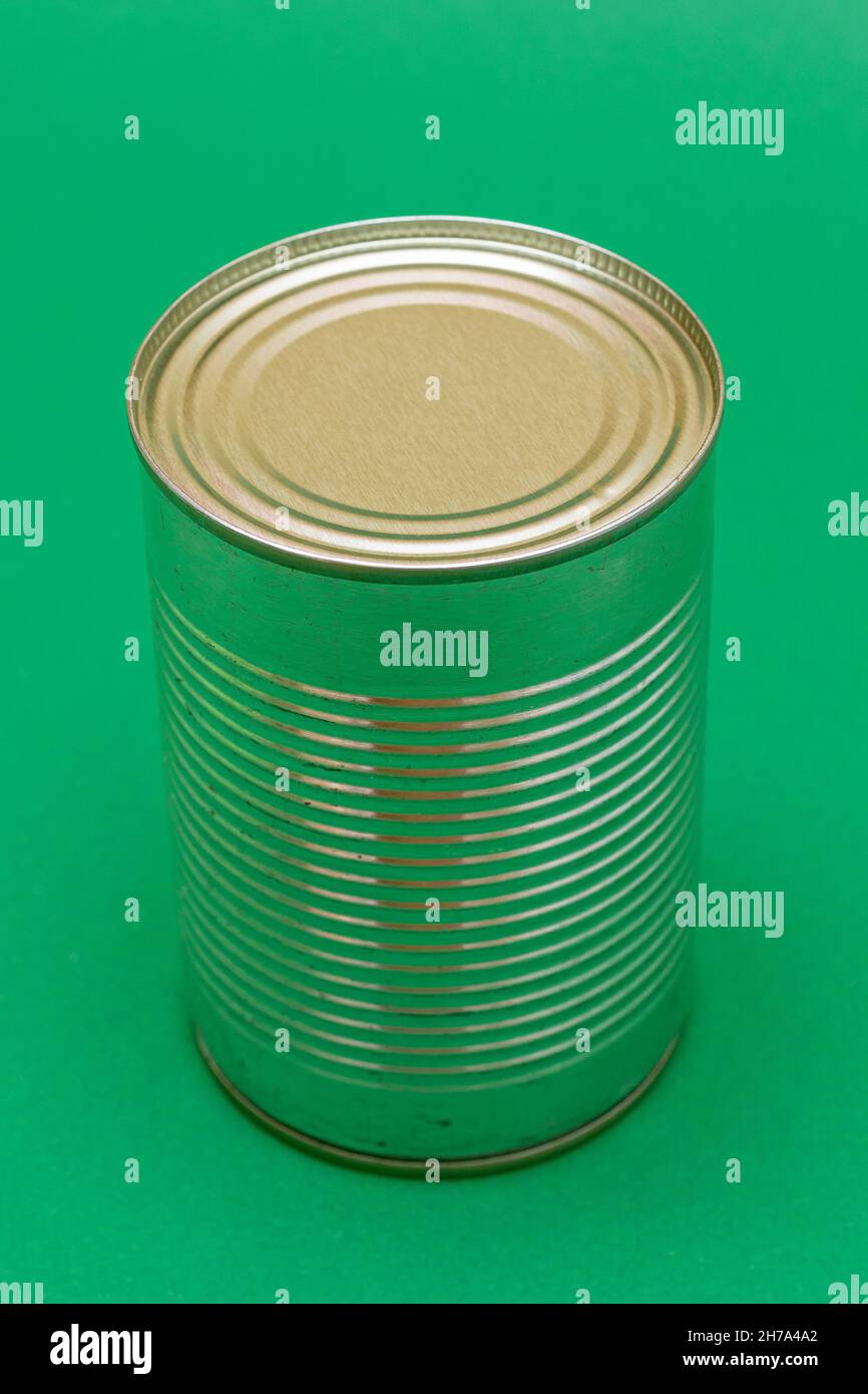 Unopened Tin Can with Blank Edge on Green Background. Canned Food