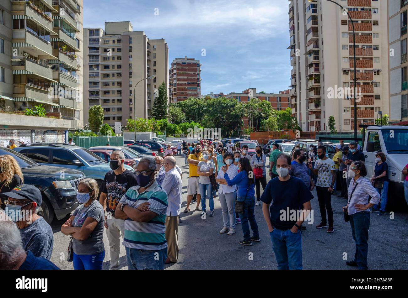 People wait outside a school as a voting center in Caracas. Venezuelans vote on Sunday, November 21, in state and municipal elections, where 23 govern Stock Photo