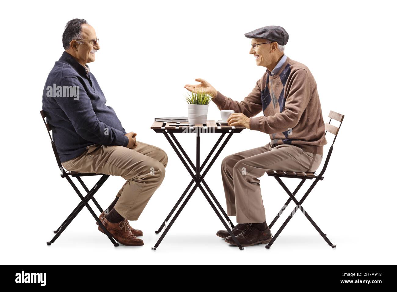 Two men are sitting at a table Cut Out Stock Images & Pictures - Alamy