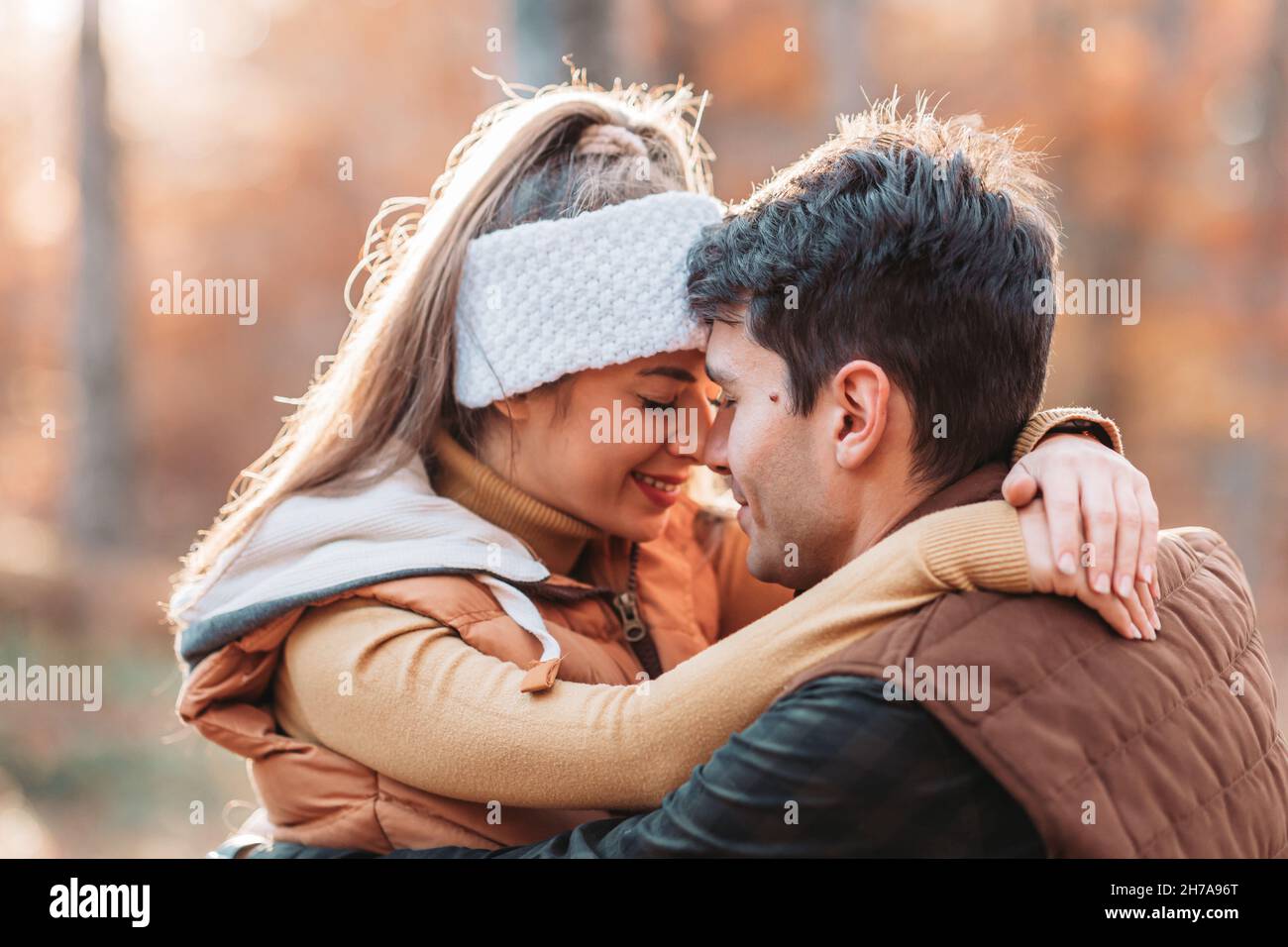 Young, romantic couple looking in love in the woods. Autumn time Stock Photo