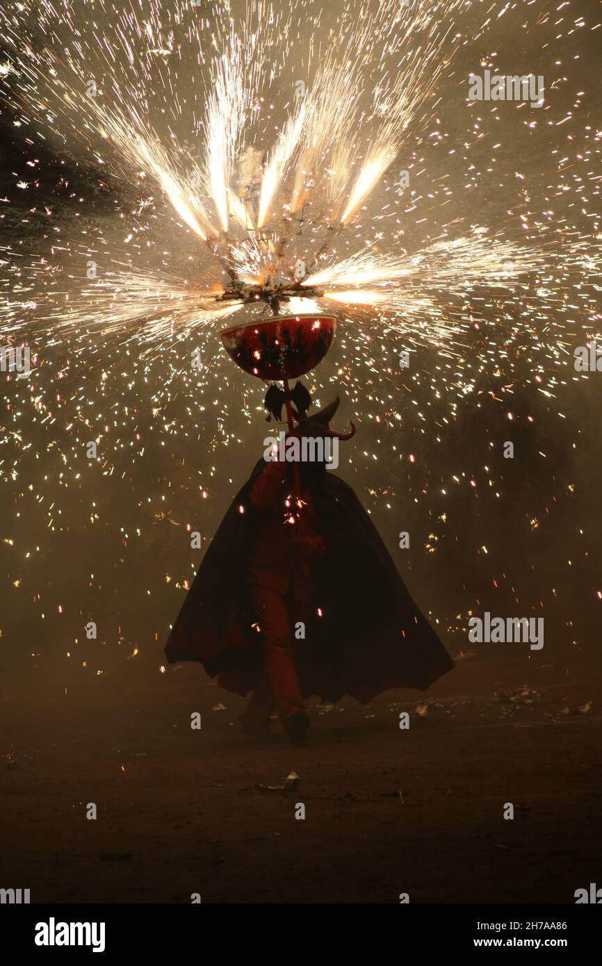 Devil silhouetted by fireworks at display in Spaind Stock Photo
