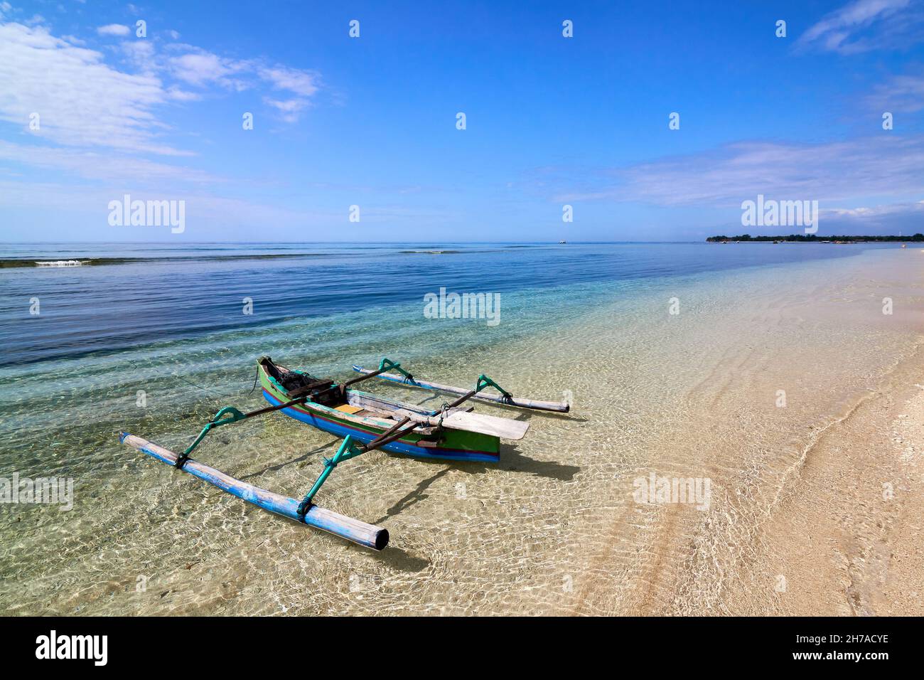 Traditional wooden boat on beautiful tropical beach at sunny morning ...