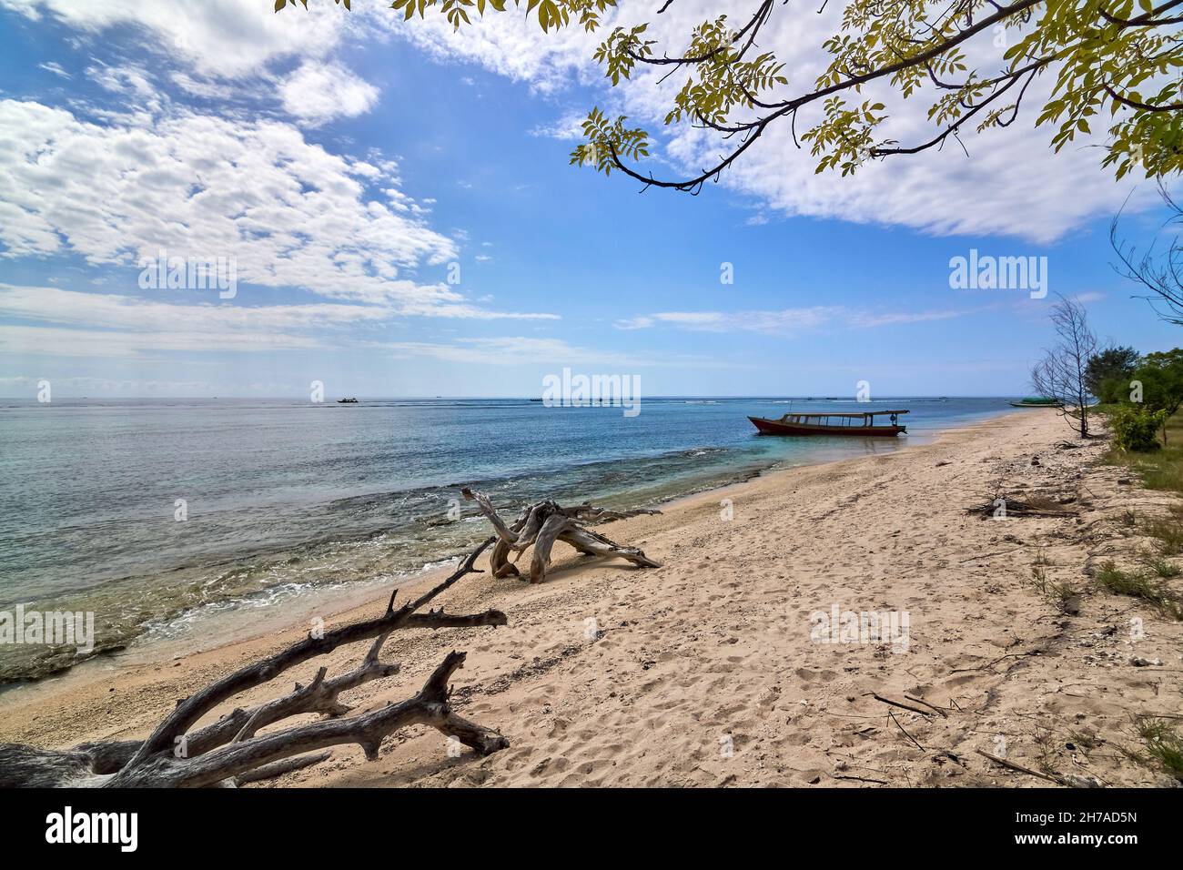 Traditional wooden boat on beautiful tropical beach at sunny morning ...