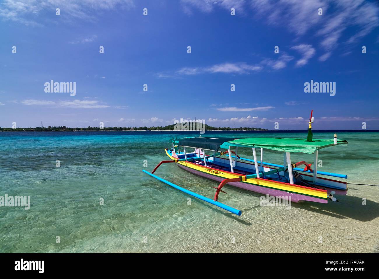 Traditional wooden boat on beautiful tropical beach at sunny morning ...