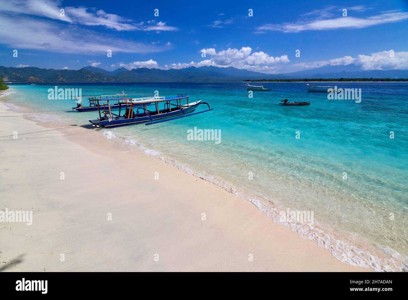 Traditional wooden boat on beautiful tropical beach at sunny morning ...