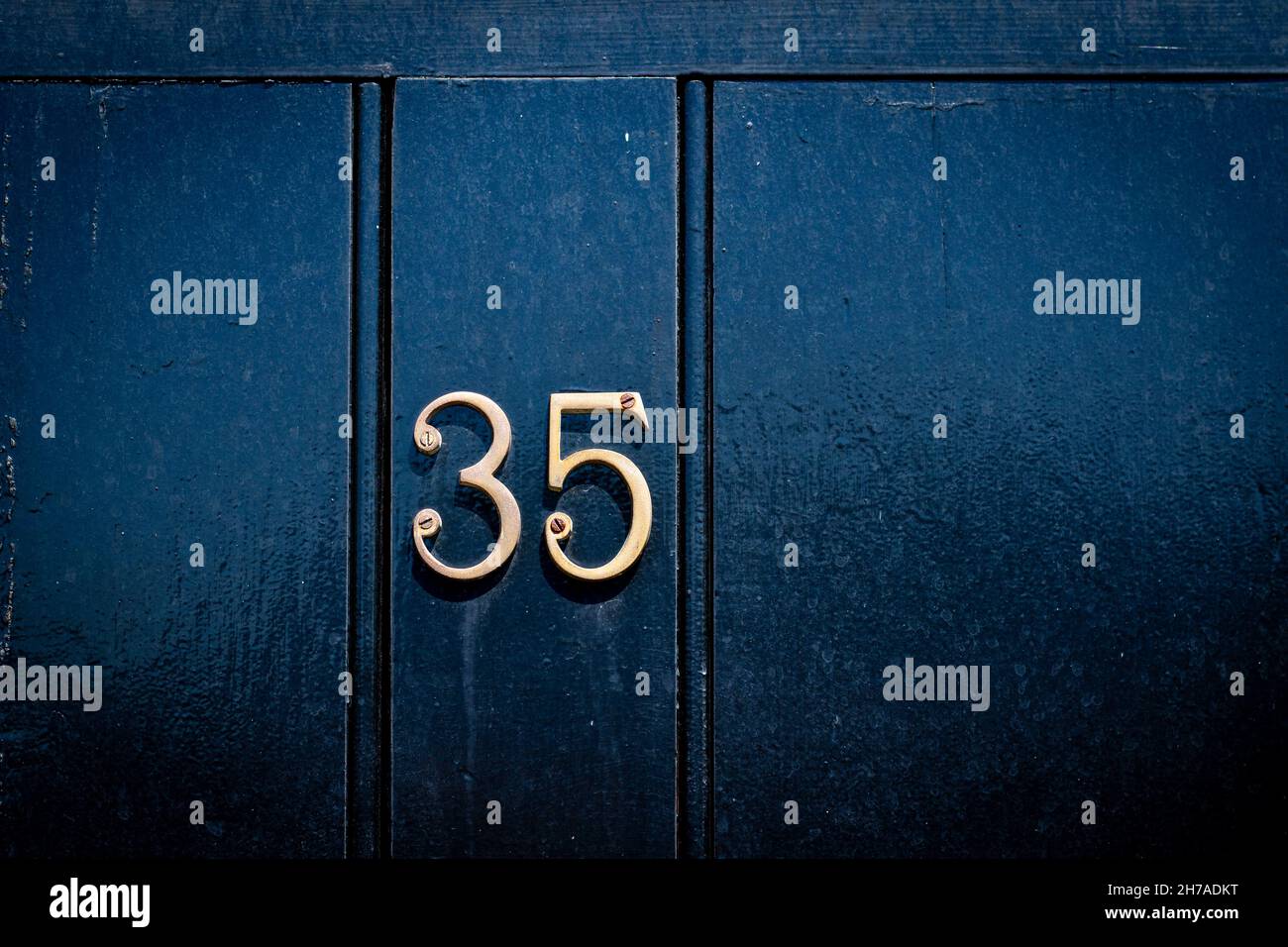 House number 35 on  black historic door Stock Photo