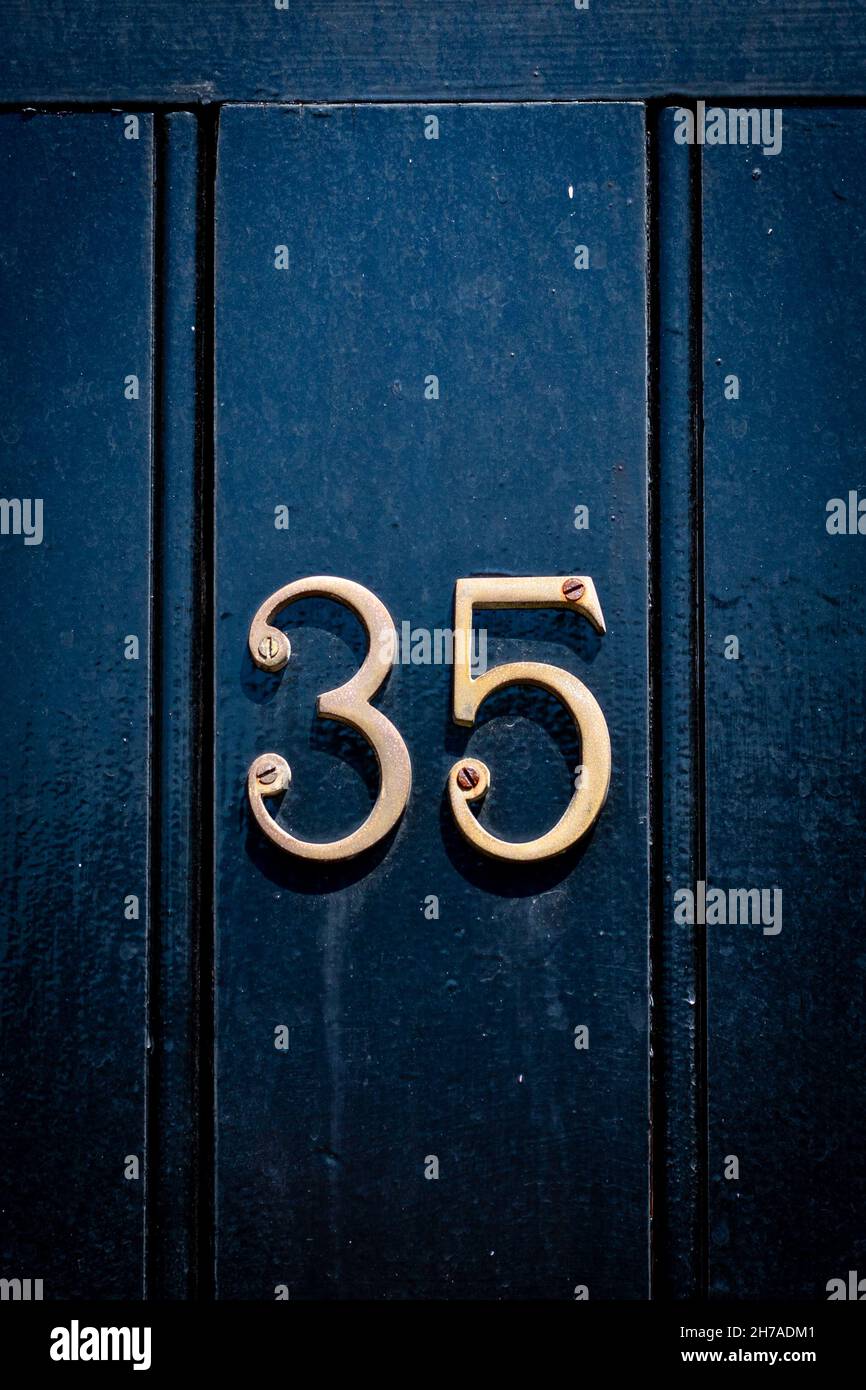 House number 35 on  black historic door Stock Photo