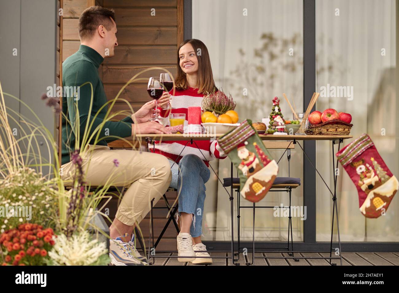 Two people sitting at the table and having a celebration Stock Photo