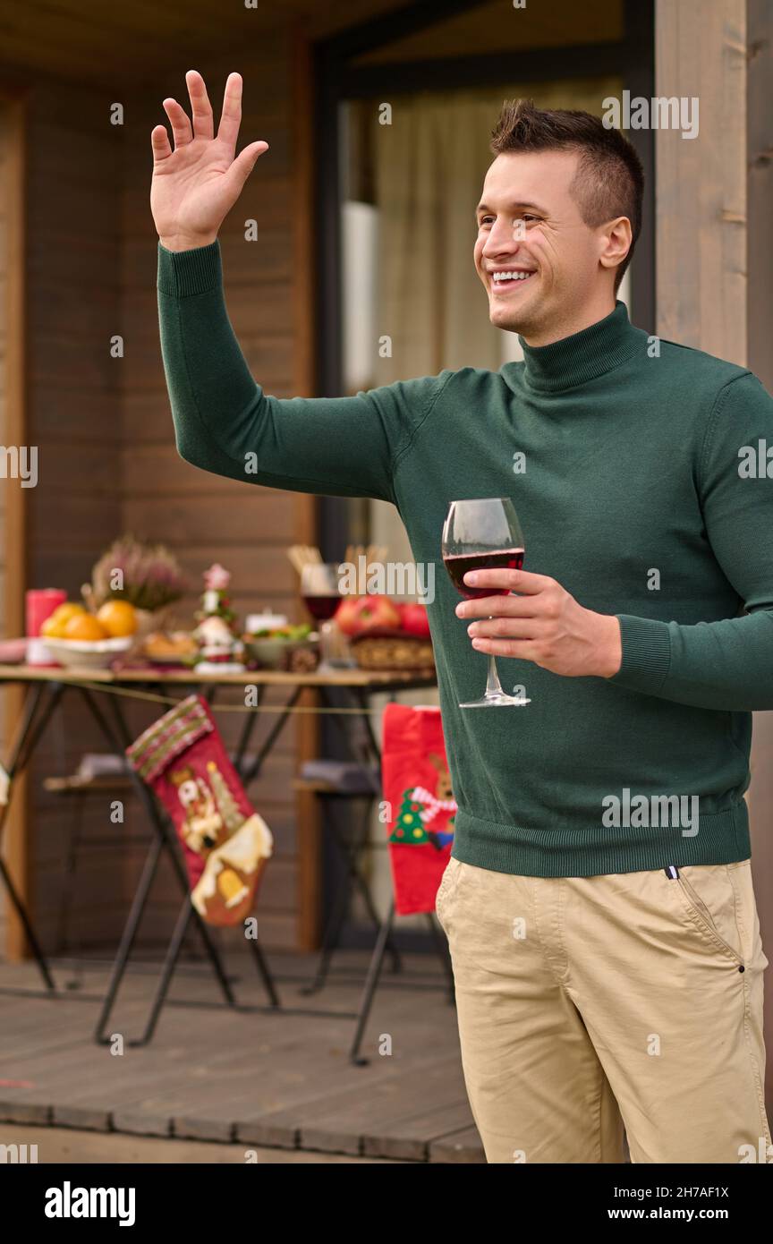 A young man with a glass of wine in hand Stock Photo