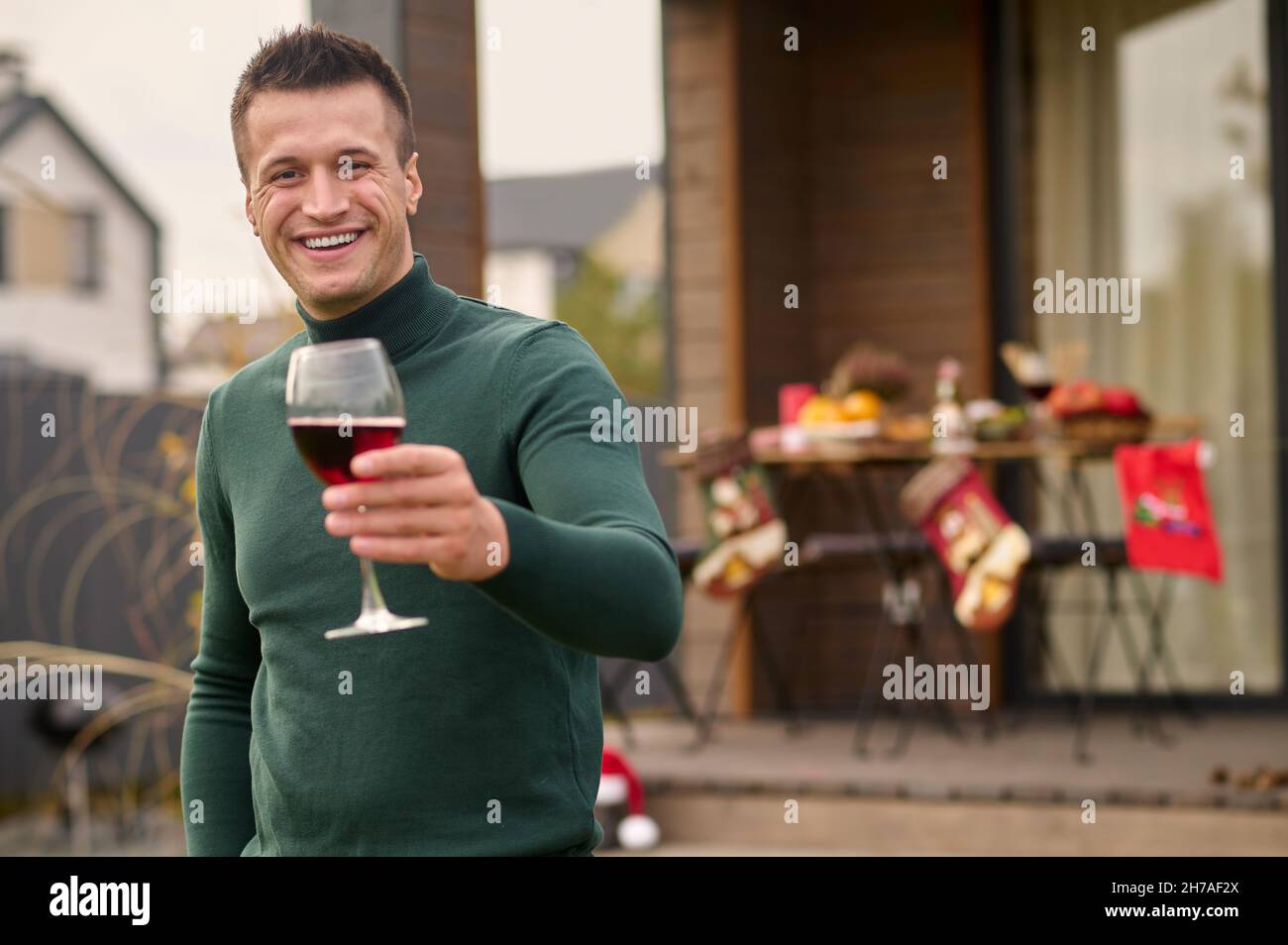 A young man with a glass of wine in hand Stock Photo