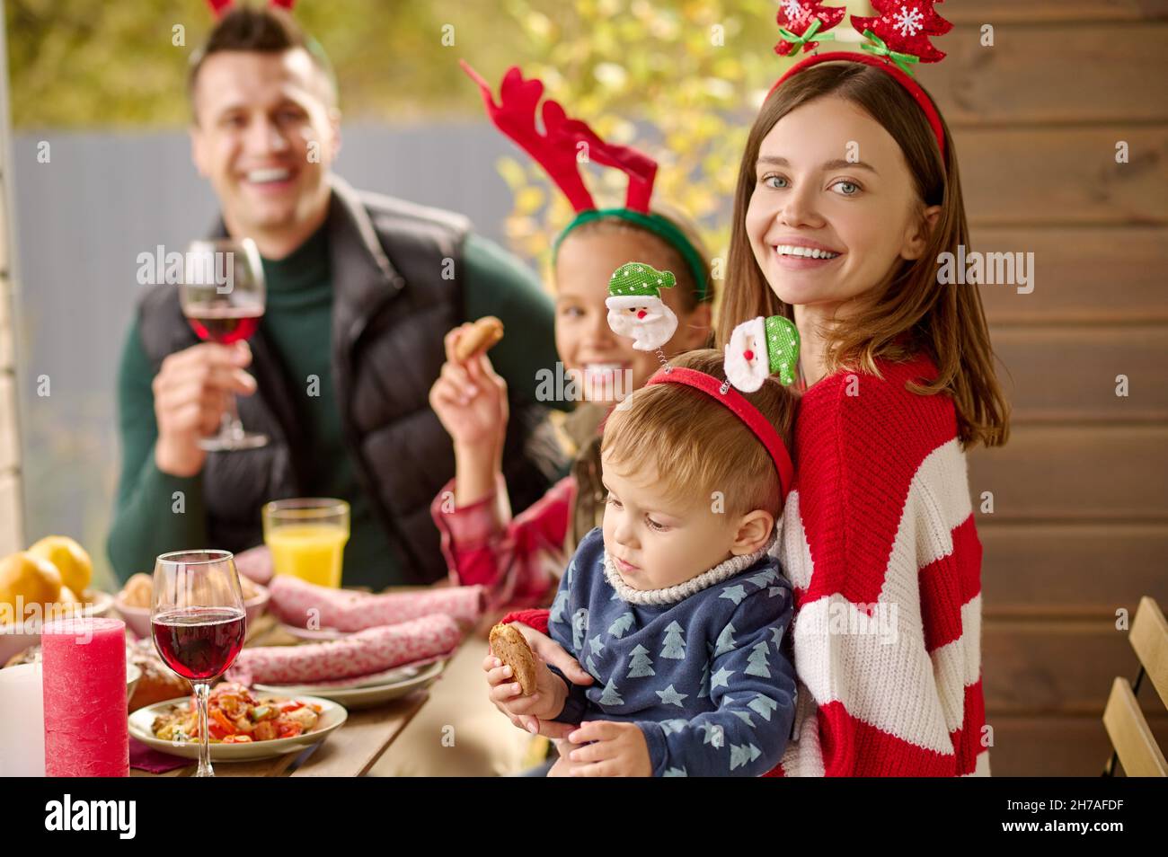 A happy family sitting at the table and celebrating christmas Stock Photo