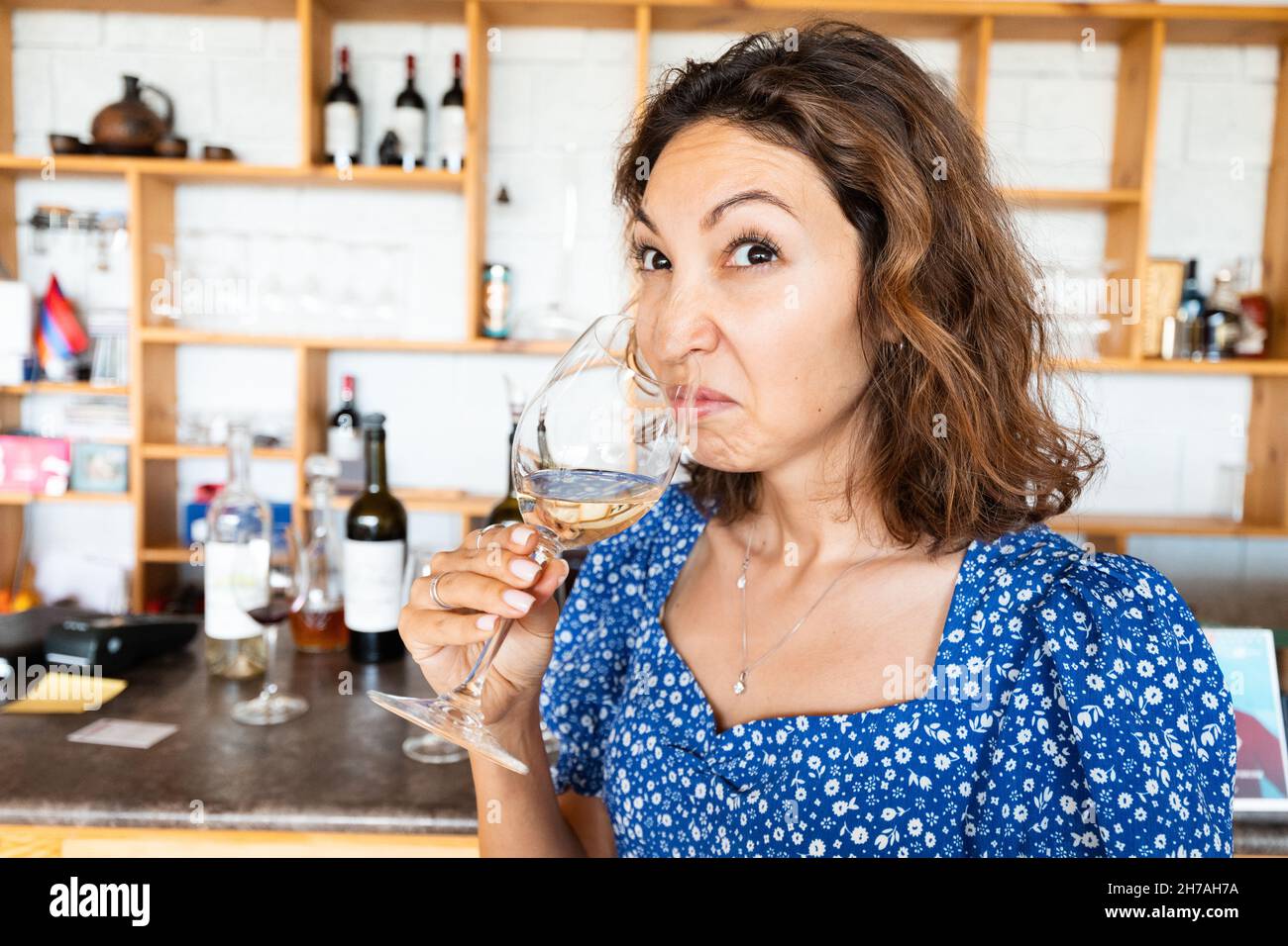 Woman sniffs and tasting bad wine. The concept of loss of sense of smell and long covid Stock