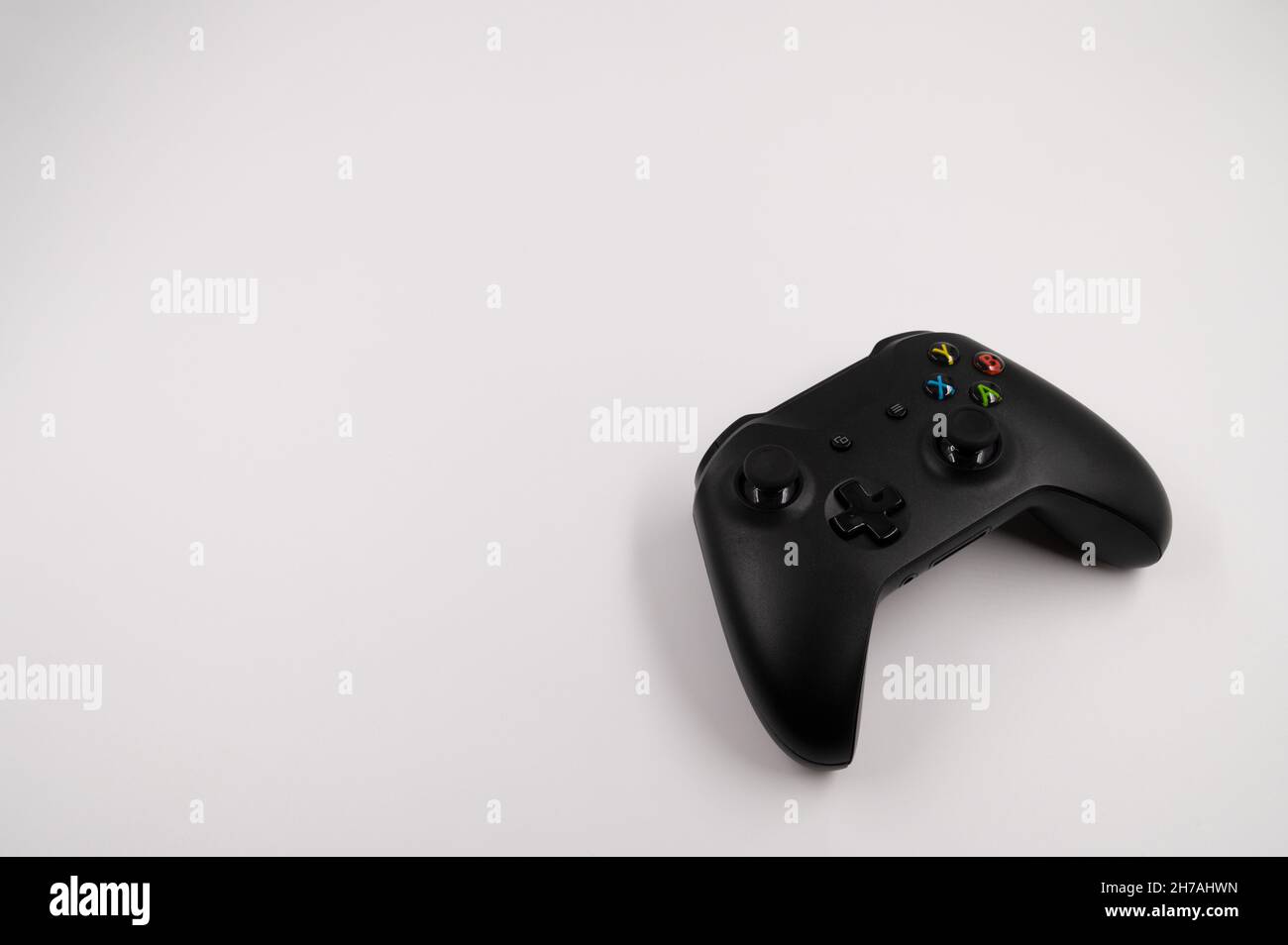 Close-up of ab lack wireless game controller with joysticks on an isolated white background. Stock Photo