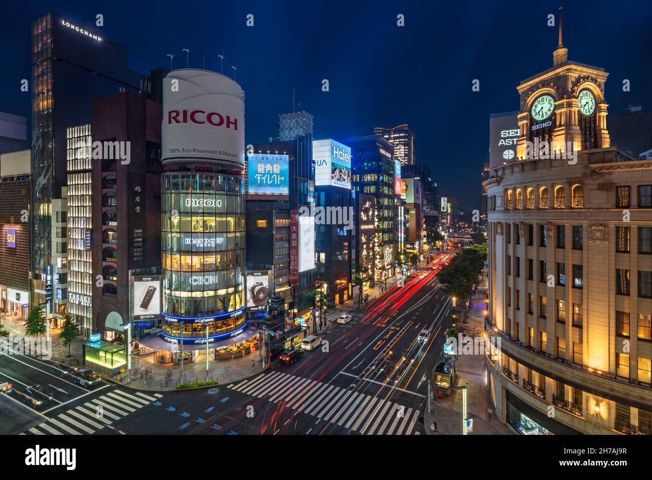 tokyo, japan - july 05 2021: Night upper view of the clock tower of the Ginza Wako building illuminated and the tower of sanai dream center at the jun Stock Photo