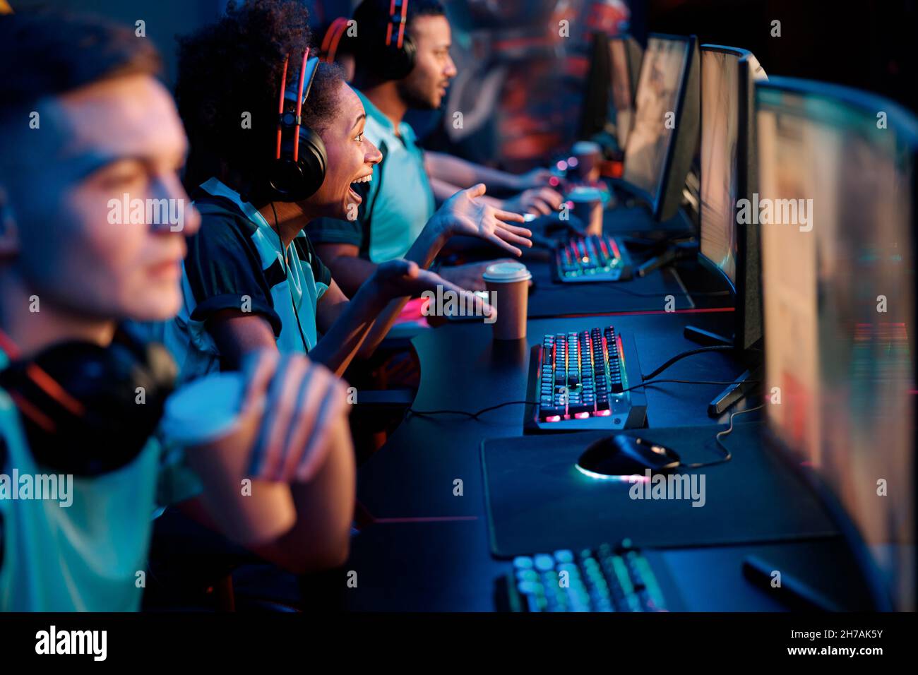 Esports team playing game on computers in gaming club Stock Photo