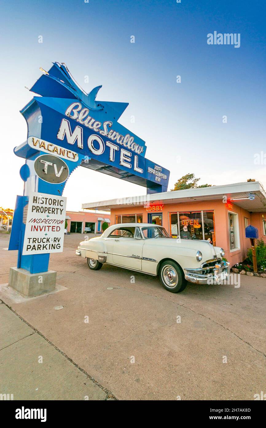 iconic blue swallow motel and sign with 1940s vintage car on the famous