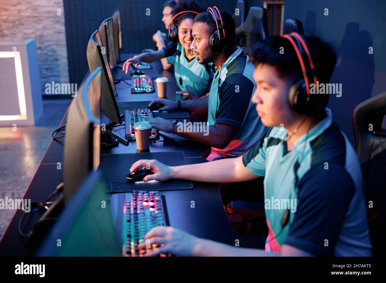 Cybersport team involved in online tournament in gaming club Stock Photo