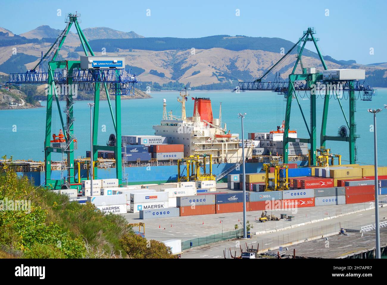Container ship loading at Lyttelton, Lyttelton Harbour, Bank's Peninsula, Canterbury, South Island, New Zealand Stock Photo