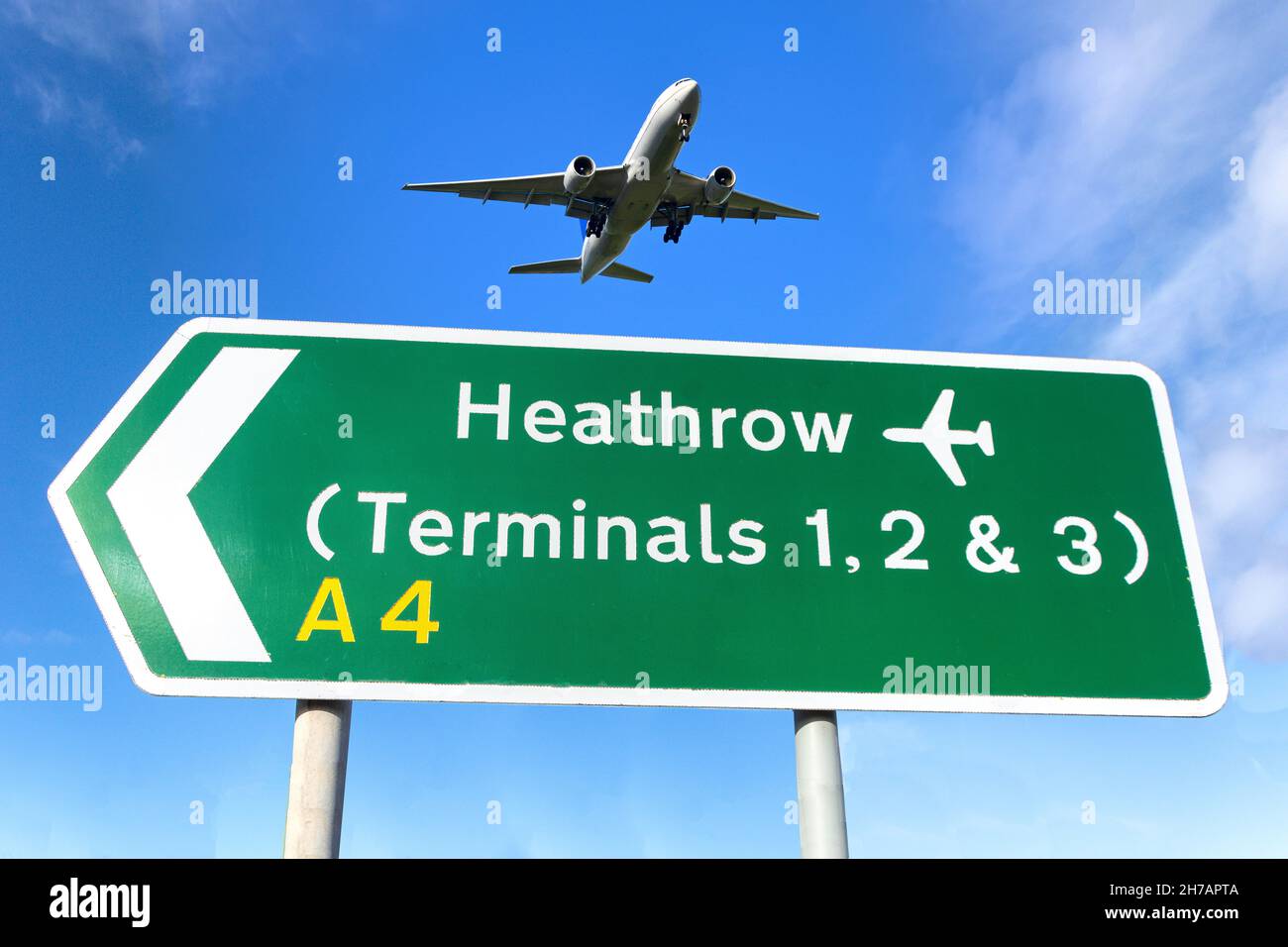 Aircraft flying over Heathrow Airport Terminals road sign, Cranford, London Borough of Hounslow, Greater London, England, United Kingdom Stock Photo