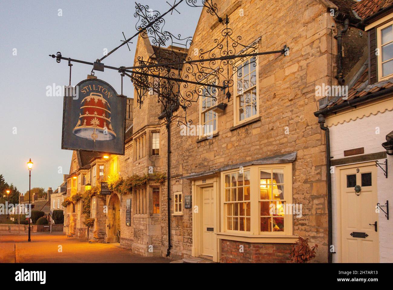 15th century The Bell Inn at dusk, High Street, Stilton, Cambridgeshire, England, United Kingdom Stock Photo
