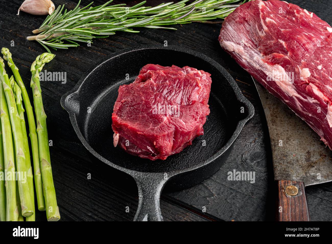 Raw beef fillet steaks with herbs and spices with whole tenderloin fillet cut set, in cast iron