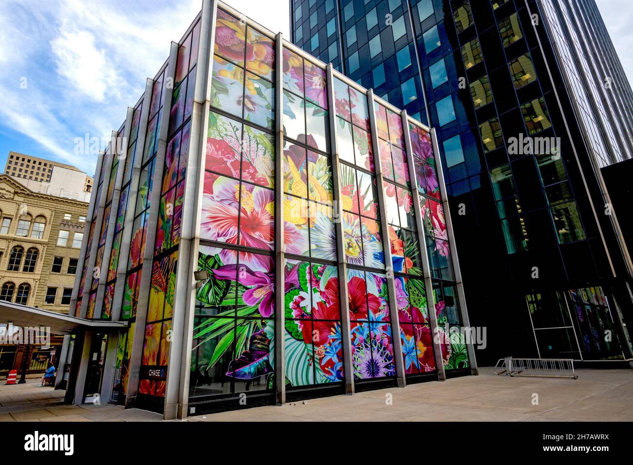 As part of the Sculpture Milwaukee project in 2019, Chicago-based artist Carlos Rolón supervised an installation of 160 vinyl panels for the exterior of the two-story glass lobby of Chase Tower, turning it into a diorama of tropical flowers called “Gild The Lilly.” It is the biggest piece in Sculpture Milwaukee’s history. Stock Photo