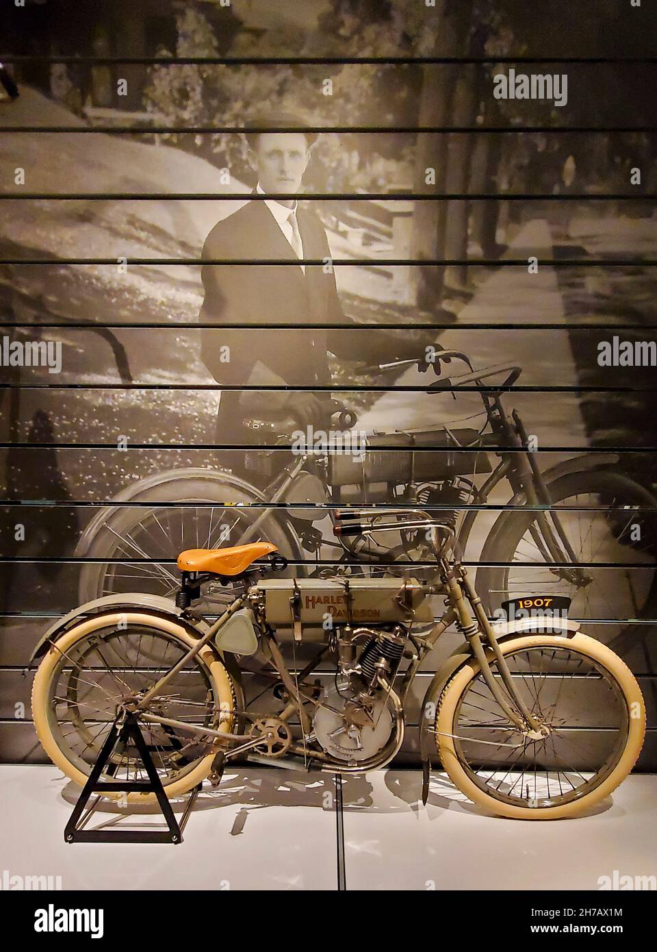 One of the first motorized bikes built by the Harley-Davidson company. In 1903 four men formed the Harley-Davidson Motor Company, which they operated out of a small shed in the Davidson family's backyard. Harley's name was given top billing because he was credited with coming up with the original idea for a motorcycle. This is their model from 1907, on display in the Harley-Davidson Museum in Milwaukee, WI. Stock Photo