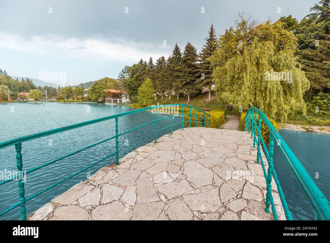 a-pedestrian-bridge-over-a-picturesque-pond-in-the-center-of-the-quiet