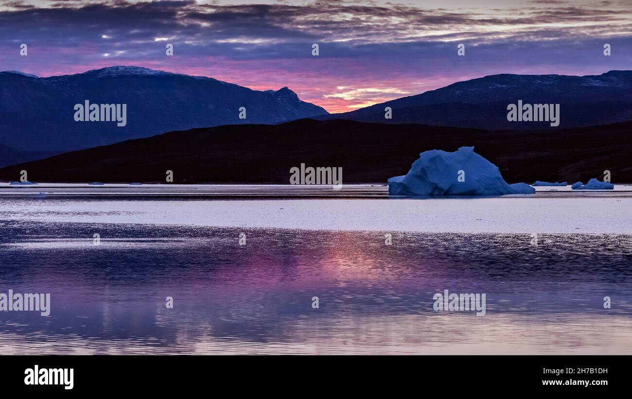 Sunrise and reflections at Harefjord, Scoresby Sund, Greenland Stock Photo