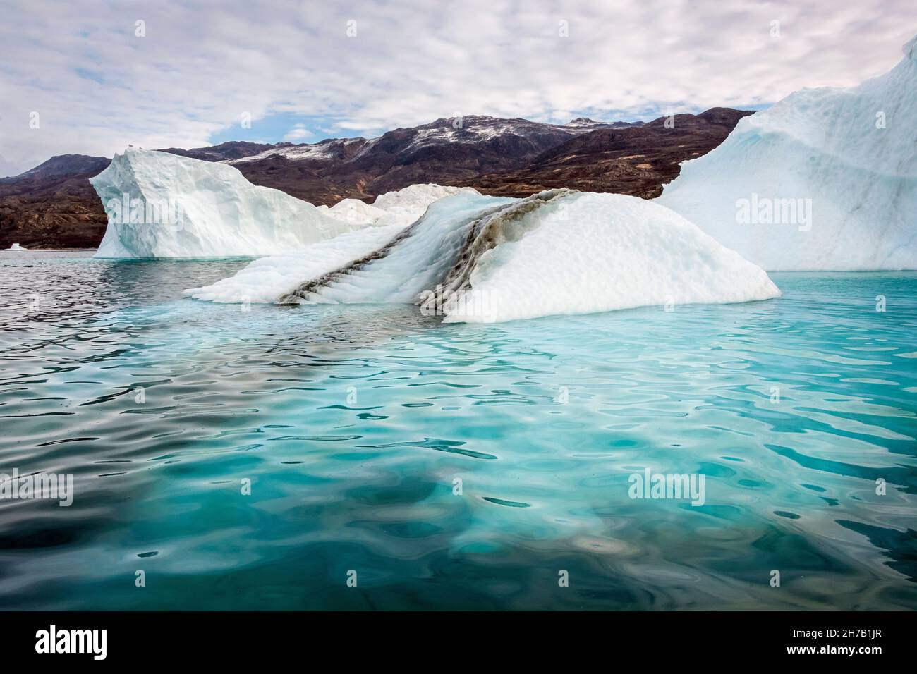 Medial moraine 'tire tracks' and shallow underwater ice shelf, Rypefjord, Scoresby Sund, Greenland Stock Photo