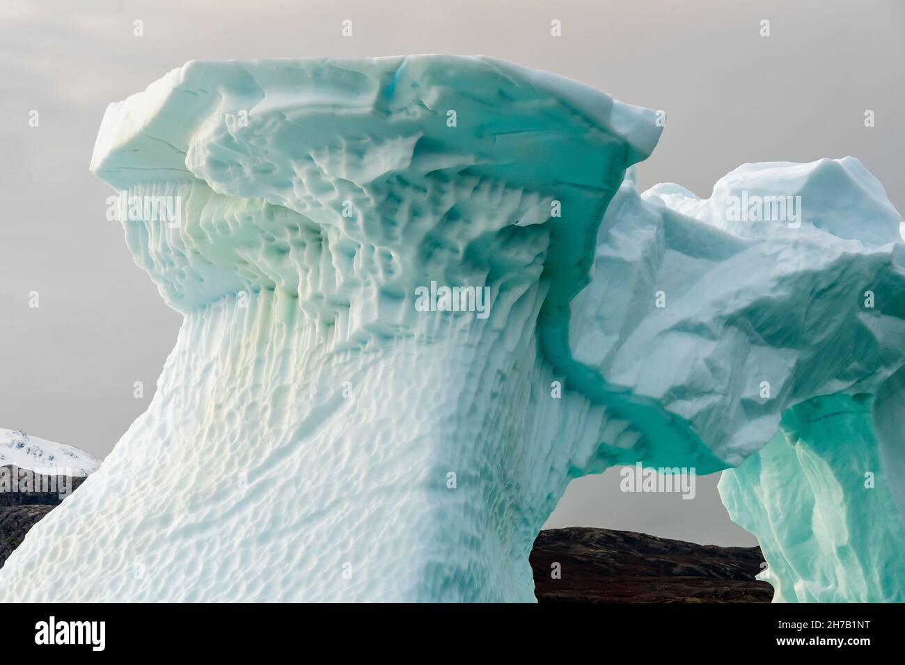 Convoluted iceberg in shades of blue, Rypefjord, Scoresby Sund, East Greenland Stock Photo