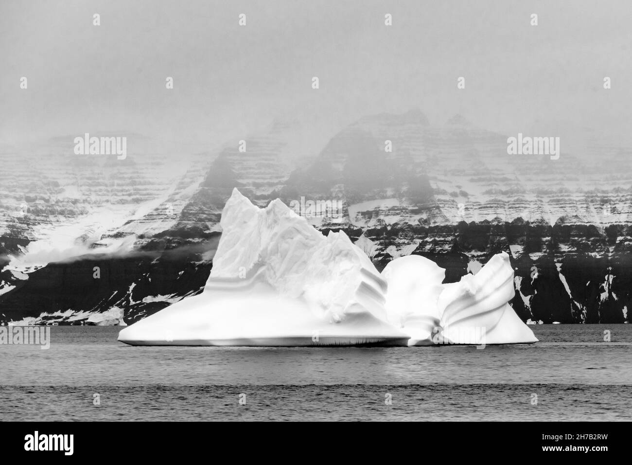 Shape and strations in land and iceberg, Geikie Plateau, Scoresby Sund, East Greenland Stock Photo