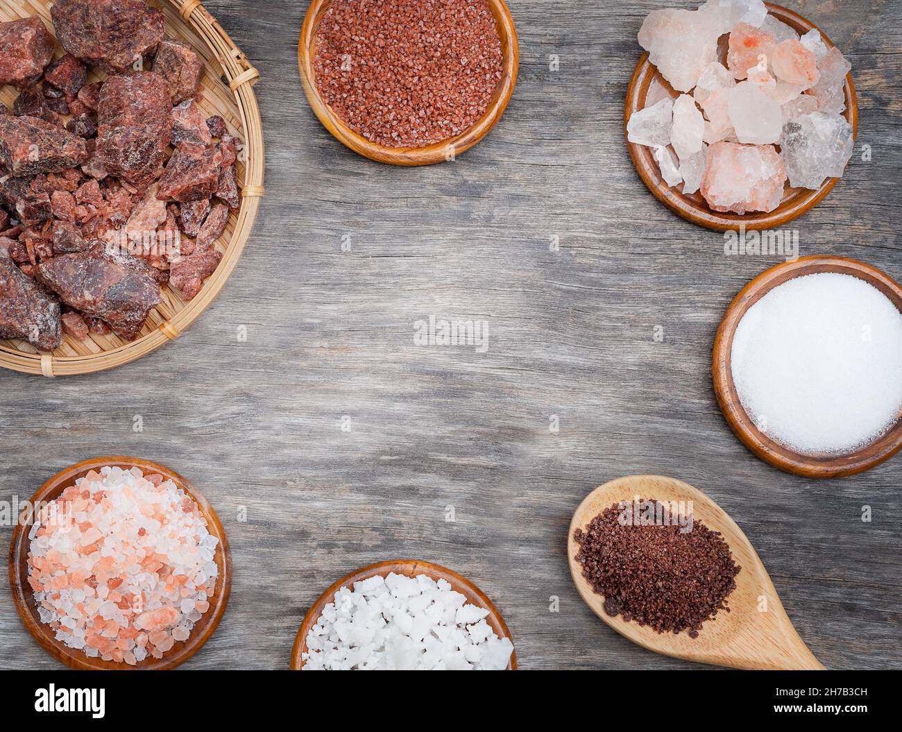 Types of salt background. Several types of salt on a wooden background Stock Photo