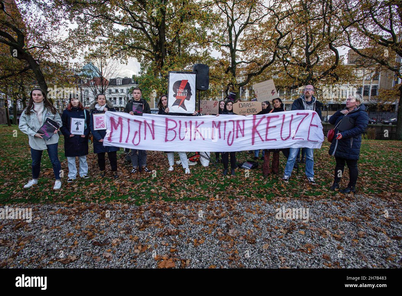 Protesters hold a banner and placards during the demonstration.A small group of protesters assembled at the Koekamp, in The Hague. denouncing Poland's new anti-abortion law, and to remember its known victim Iza, 30-year-old, a would be mother with no medical complications, died in September due to septic shock. Hospital doctors in Pszczyna, Southern Poland, would not terminate her 22-week pregnancy, even though the fetus had no chance of survival. Doctors now have to wait for the fetus to die in a natural way before an abortion is performed. Women's rights activists say the woman was a victim Stock Photo