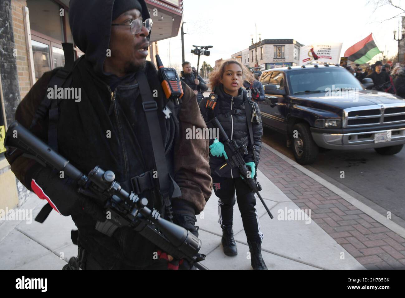 Kenosha, Wisconsin, USA. 19th Nov, 2021. ERICK JORDAN and his daughter JADE  JORDAN, 16, provide armed security as Jacob Blake's uncle Justin Blake  leads a march downtown after a rally in Civic