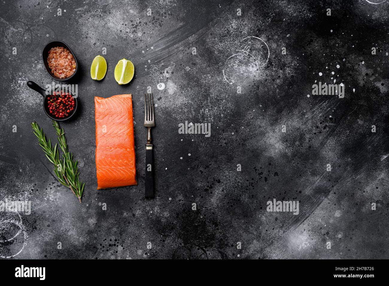 Salmon. Fresh raw salmon fish fillet set, with herbs, on black dark