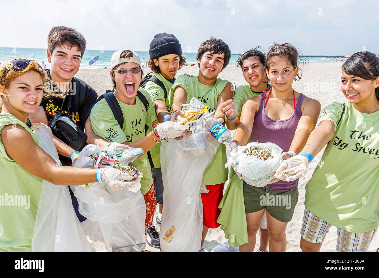Children picking up litter from beach hires stock photography and