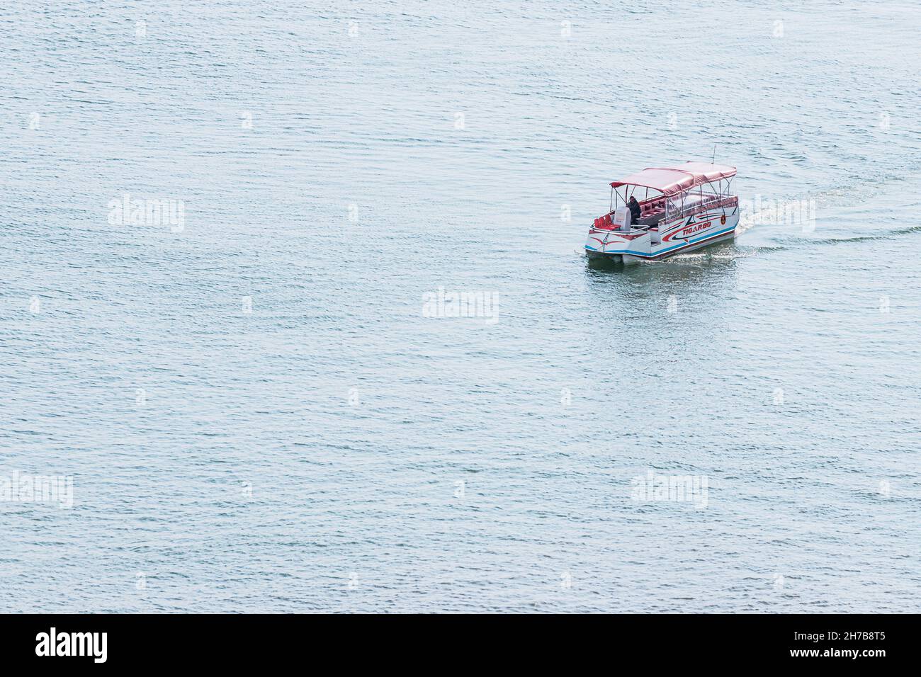 23 May 2021, Sevan, Armenia: pleasure boat without for tourists during bad weather on Lake Sevan in Armenia. Tigarbo caption on the ship Stock Photo