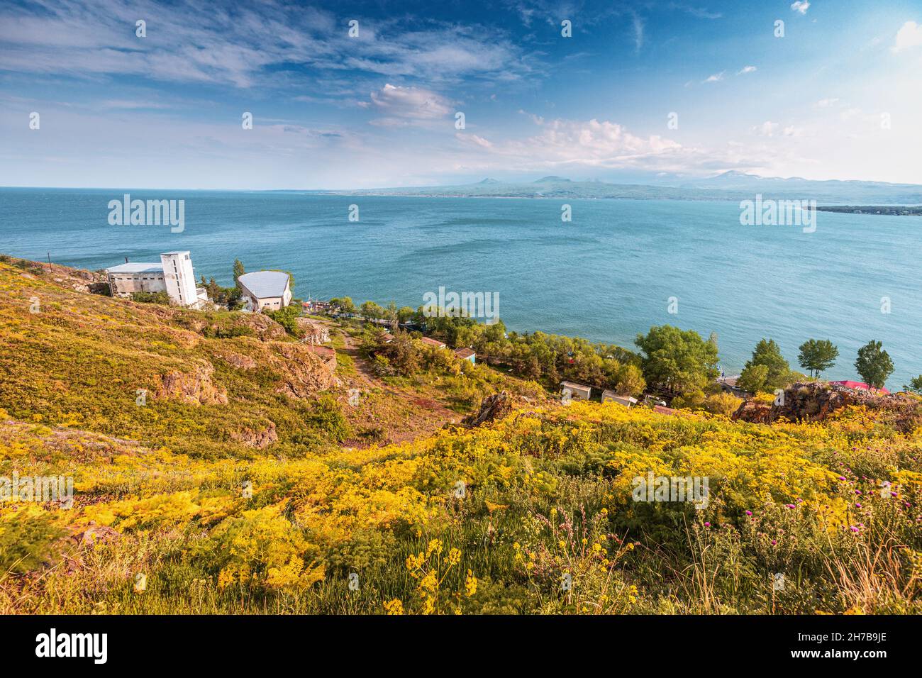 Dramatic landscape with hotel buildings on famous Lake Sevan. Natural travel destinations in Armenia Stock Photo