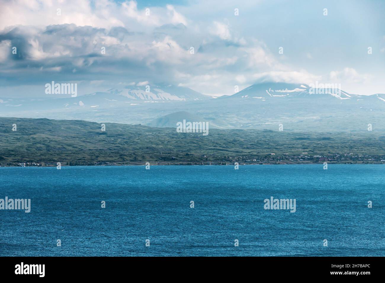 Atmospheric and mood landscape in stormy weather with strong wind on Lake Sevan as background Stock Photo