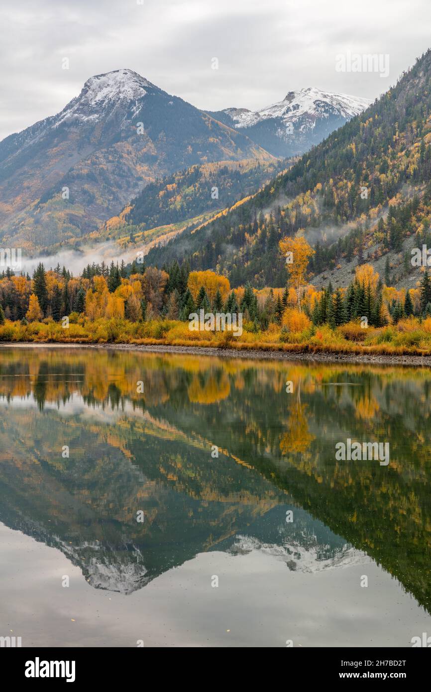 Aspen and snow-capped mountain reflected in a pond near Marble, White River National Forest, Colorado Stock Photo